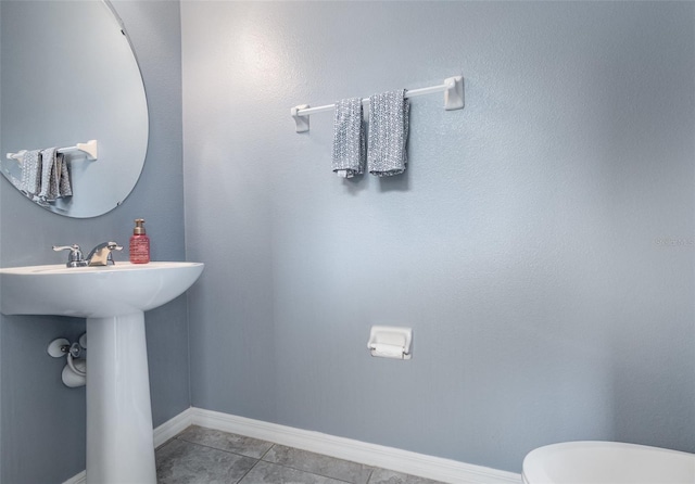 bathroom with tile patterned floors and toilet