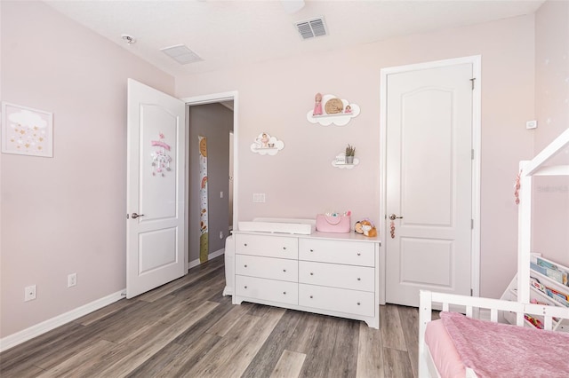 bedroom with dark hardwood / wood-style flooring