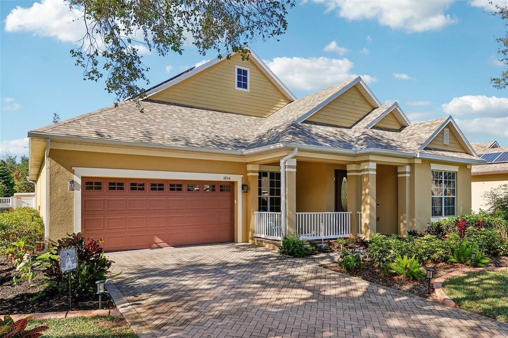 view of front of house with a porch and a garage