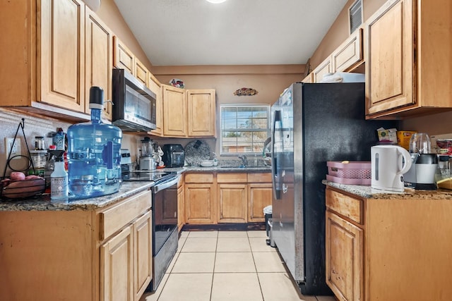 kitchen featuring black appliances, sink, decorative backsplash, light tile patterned floors, and light brown cabinetry