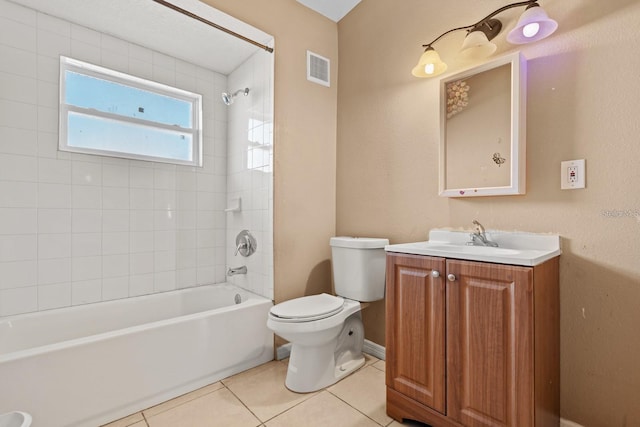 full bathroom with vanity, tiled shower / bath, tile patterned floors, and toilet