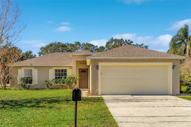 view of front of property with a front yard and a garage