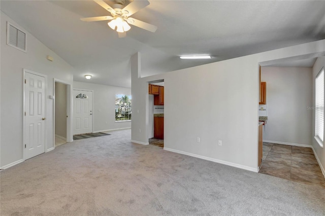 carpeted spare room with ceiling fan and lofted ceiling