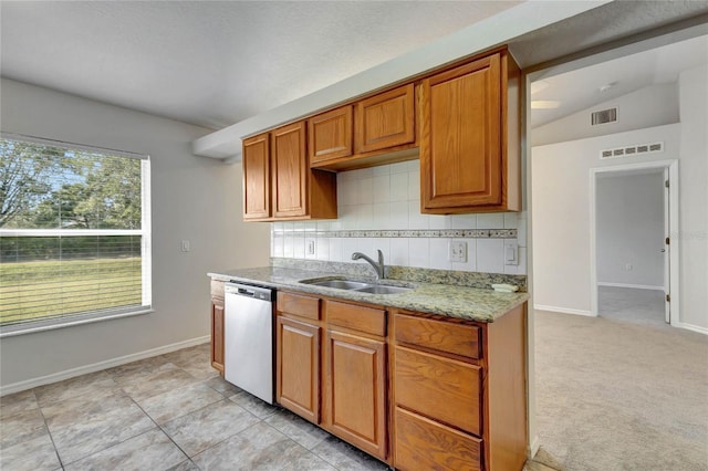 kitchen with stainless steel dishwasher, vaulted ceiling, sink, light colored carpet, and tasteful backsplash