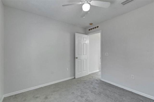 spare room featuring ceiling fan and light carpet