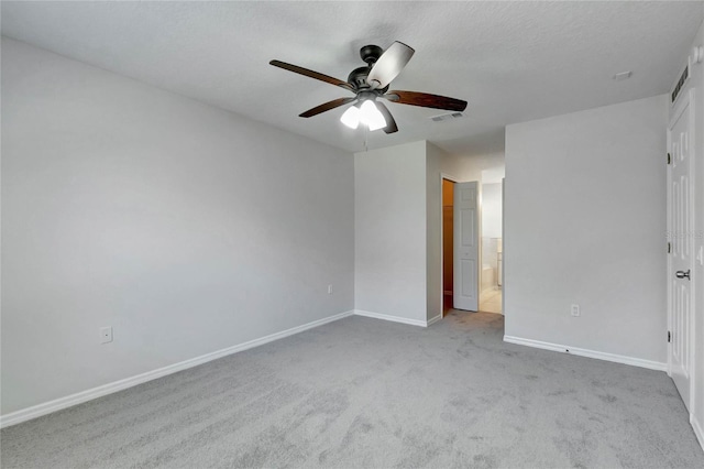 spare room featuring light carpet and ceiling fan