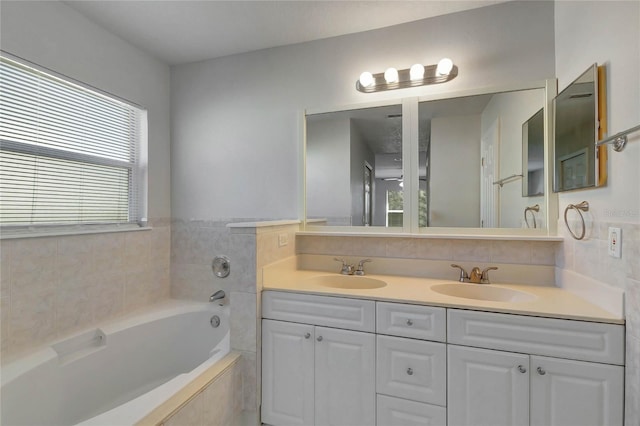 bathroom with vanity and tiled bath