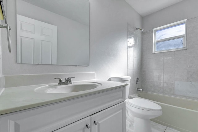 full bathroom with toilet, tiled shower / bath, tile patterned flooring, and vanity