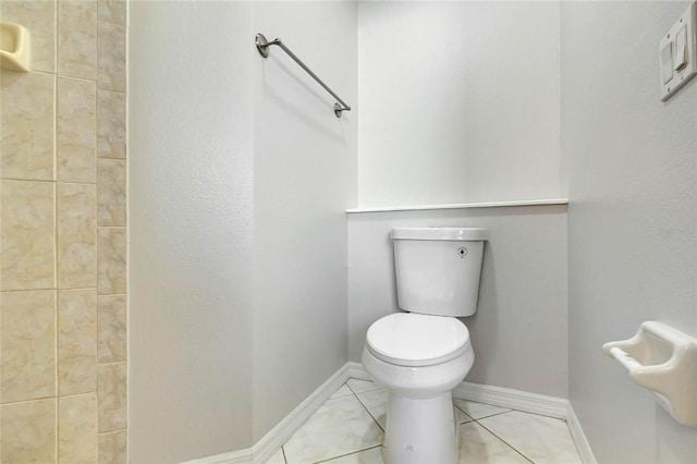 bathroom featuring toilet and tile patterned flooring