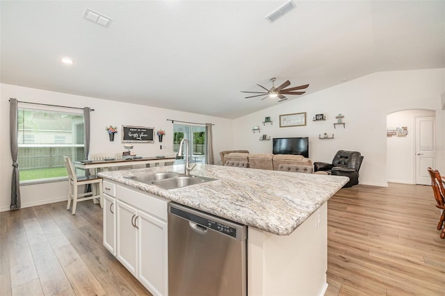 kitchen with dishwasher, a center island with sink, vaulted ceiling, and sink