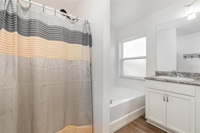 bathroom featuring hardwood / wood-style floors, a bathtub, and vanity