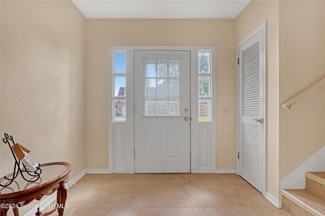 foyer entrance featuring light tile patterned floors