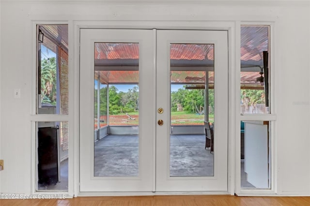 entryway with wood-type flooring and french doors