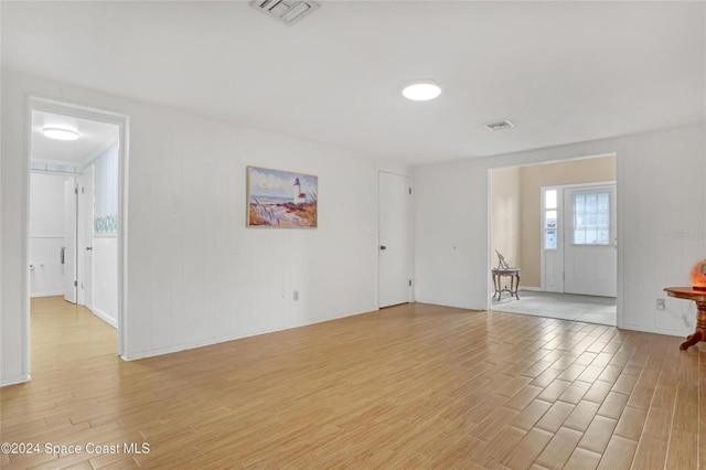 spare room featuring a wealth of natural light and light wood-type flooring