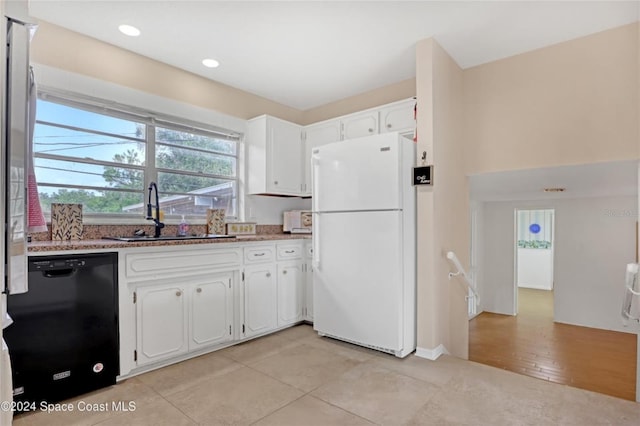 kitchen featuring sink, dishwasher, white fridge, white cabinetry, and light tile patterned flooring