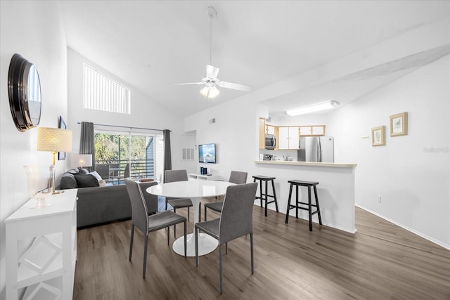 dining room featuring dark hardwood / wood-style flooring, ceiling fan, and lofted ceiling