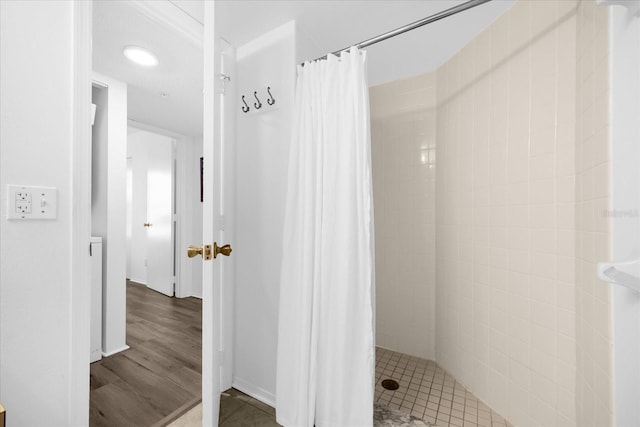 bathroom featuring hardwood / wood-style flooring and walk in shower