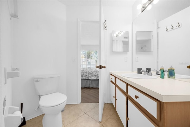 bathroom with tile patterned floors, vanity, and toilet