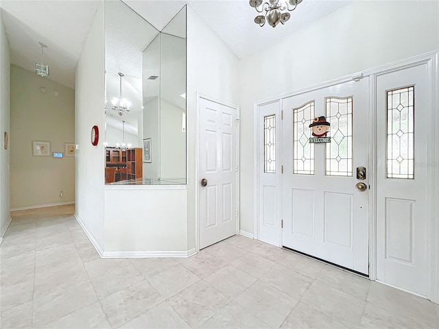 foyer entrance with a chandelier and high vaulted ceiling