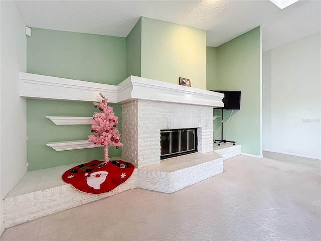 unfurnished living room featuring a fireplace, carpet floors, and a textured ceiling