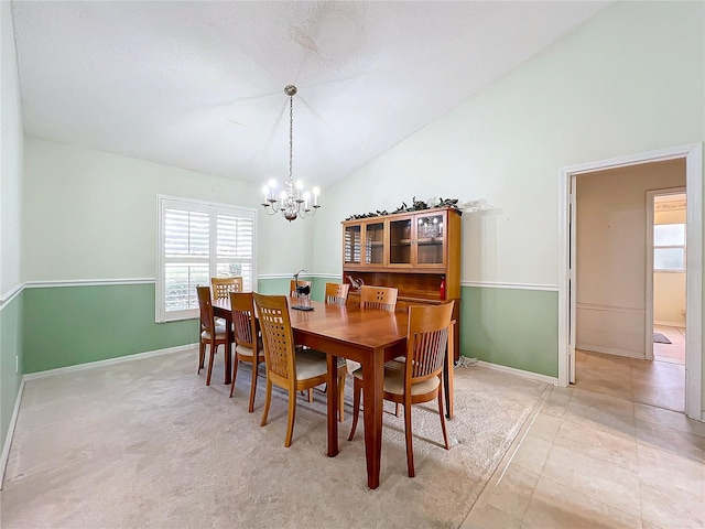 dining room with vaulted ceiling and a notable chandelier