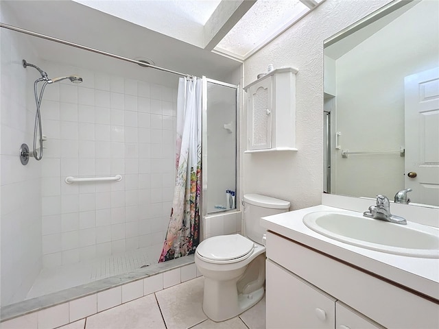 bathroom featuring curtained shower, tile patterned flooring, vanity, and toilet