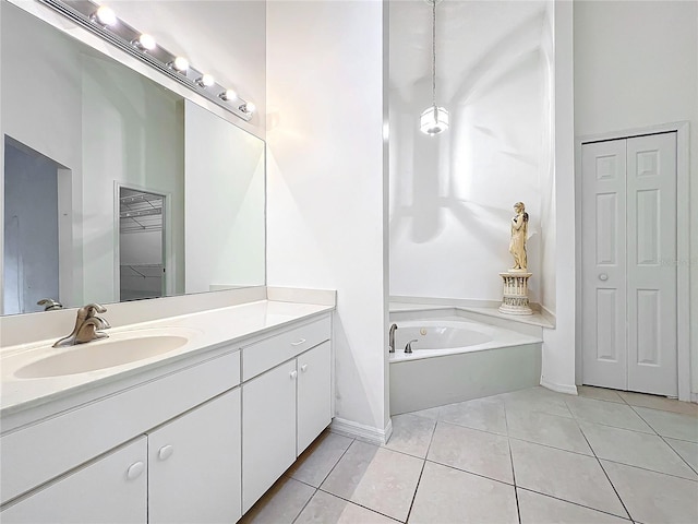 bathroom featuring tile patterned floors, vanity, and a bath