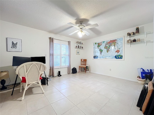 miscellaneous room with ceiling fan, light tile patterned flooring, and a textured ceiling