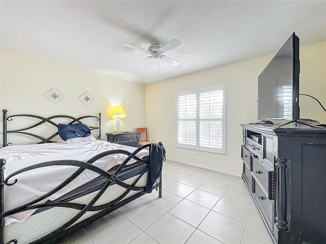 tiled bedroom with ceiling fan and a textured ceiling