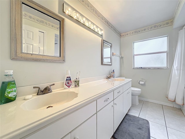 bathroom with tile patterned flooring, vanity, and toilet