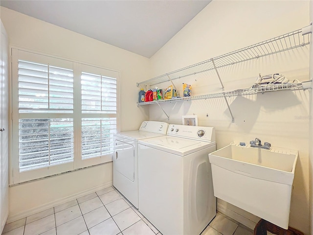 washroom featuring separate washer and dryer, sink, and light tile patterned floors