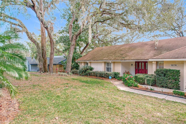 ranch-style home with a front lawn