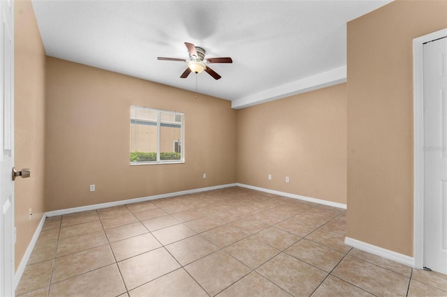 tiled empty room featuring ceiling fan