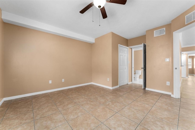 tiled spare room with ceiling fan