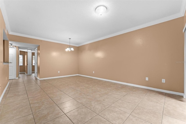 tiled spare room with a notable chandelier and ornamental molding