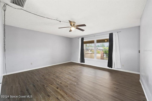 spare room featuring dark hardwood / wood-style floors and ceiling fan