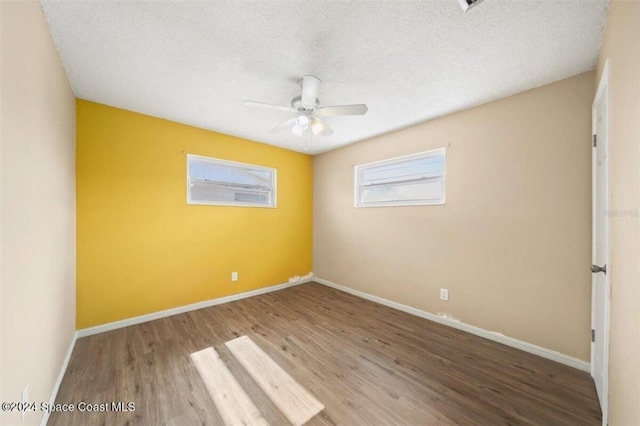 empty room featuring hardwood / wood-style floors, a textured ceiling, and ceiling fan