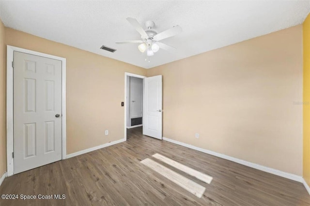 unfurnished bedroom featuring ceiling fan and wood-type flooring