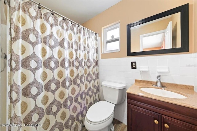 bathroom featuring vanity, hardwood / wood-style flooring, toilet, tile walls, and curtained shower