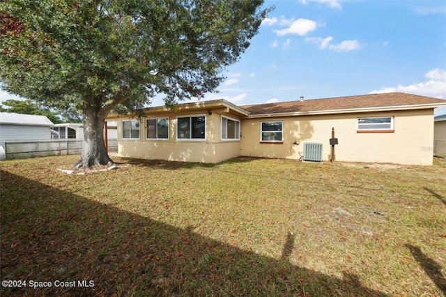 back of property featuring a yard and central AC unit