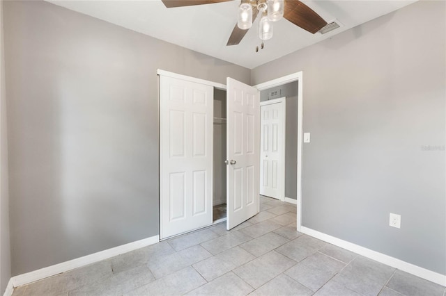 unfurnished bedroom featuring ceiling fan, light tile patterned flooring, and a closet