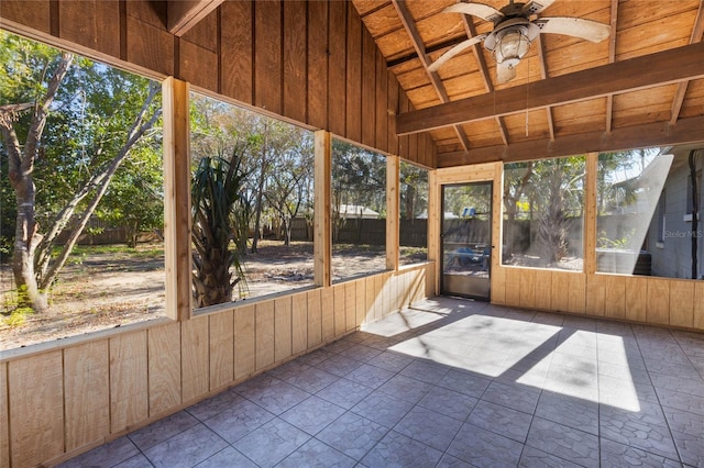 unfurnished sunroom with ceiling fan and vaulted ceiling