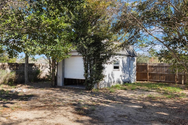 back of property featuring an outdoor structure