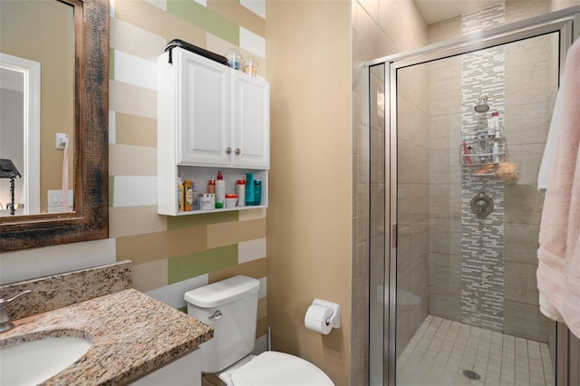 bathroom featuring toilet, an enclosed shower, and vanity