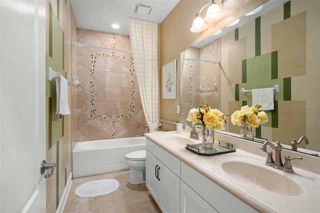 full bathroom with tile patterned flooring, toilet, vanity, and tiled shower / bath