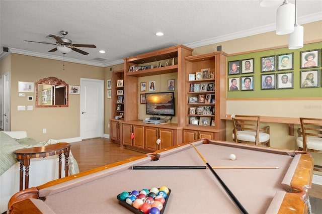 recreation room featuring a textured ceiling, crown molding, and billiards