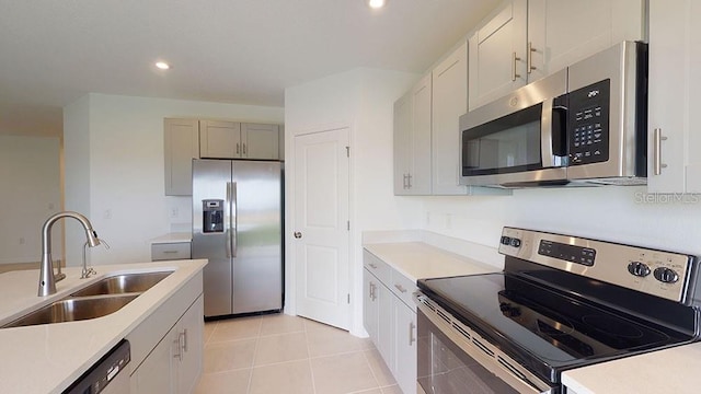 kitchen featuring light tile patterned floors, stainless steel appliances, and sink