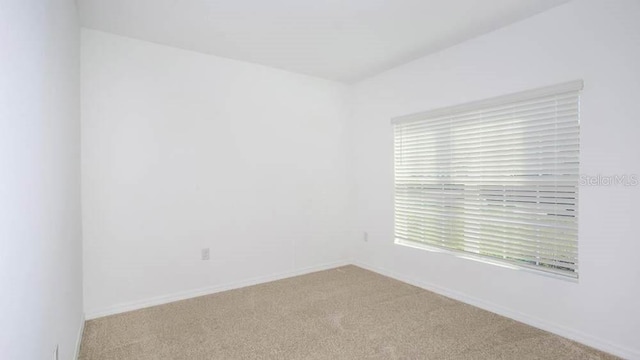 empty room with light colored carpet