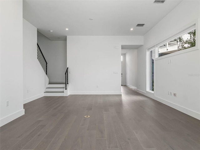 unfurnished living room featuring dark hardwood / wood-style flooring