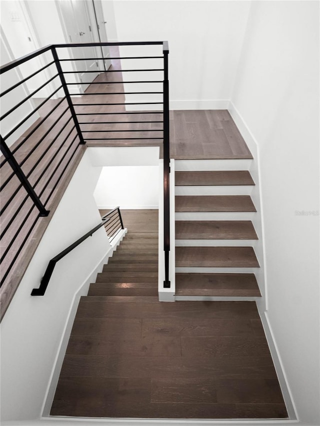 staircase featuring hardwood / wood-style flooring